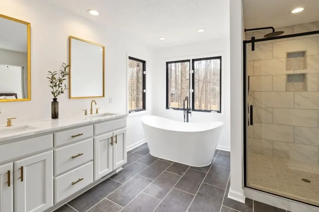 bathroom with different tiles on main floor and shower